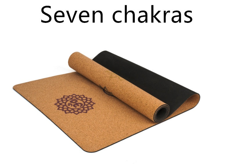 Cork yoga mat with seven-chakra pattern shown partly rolled.