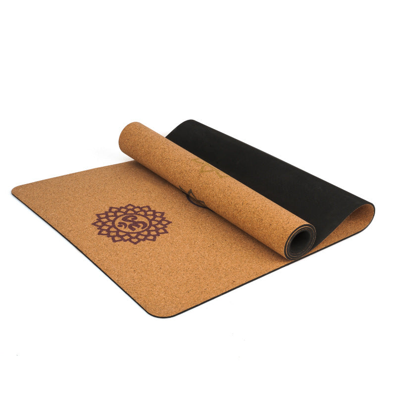 Rolled cork yoga mat with seven-chakra pattern on a white background.