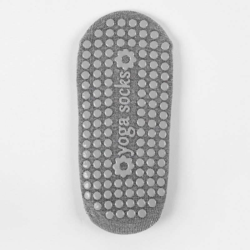 Gray Pilates and yoga sock showing the textured grip sole