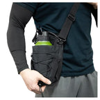 Black gym bottle bag worn across the body with its shoulder strap.